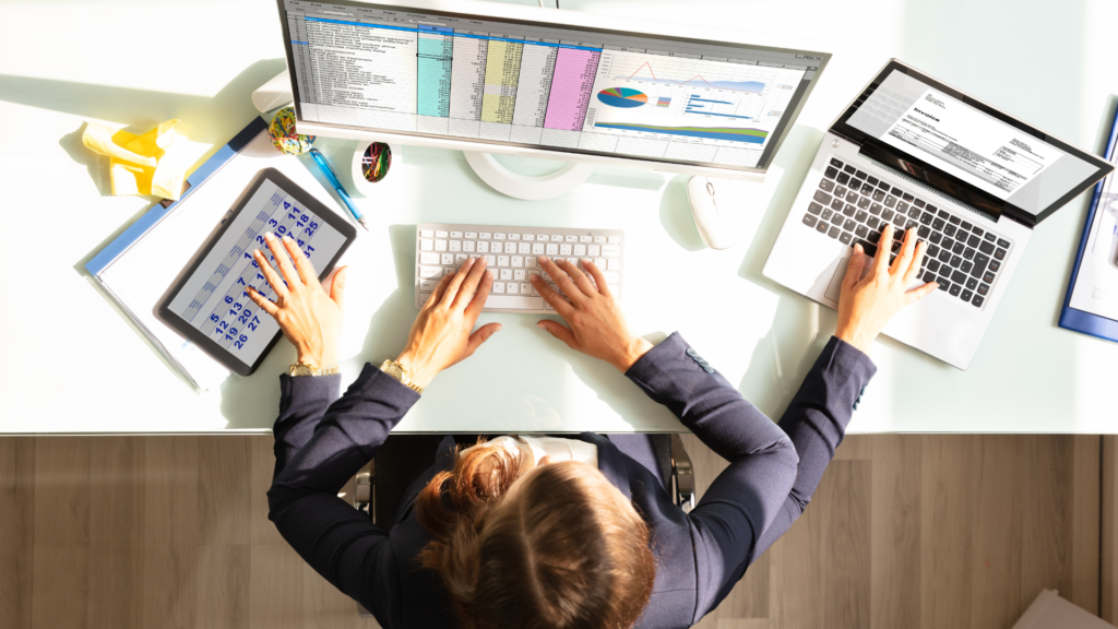 woman multitasking with multiple arms on laptop and notebook and tablet