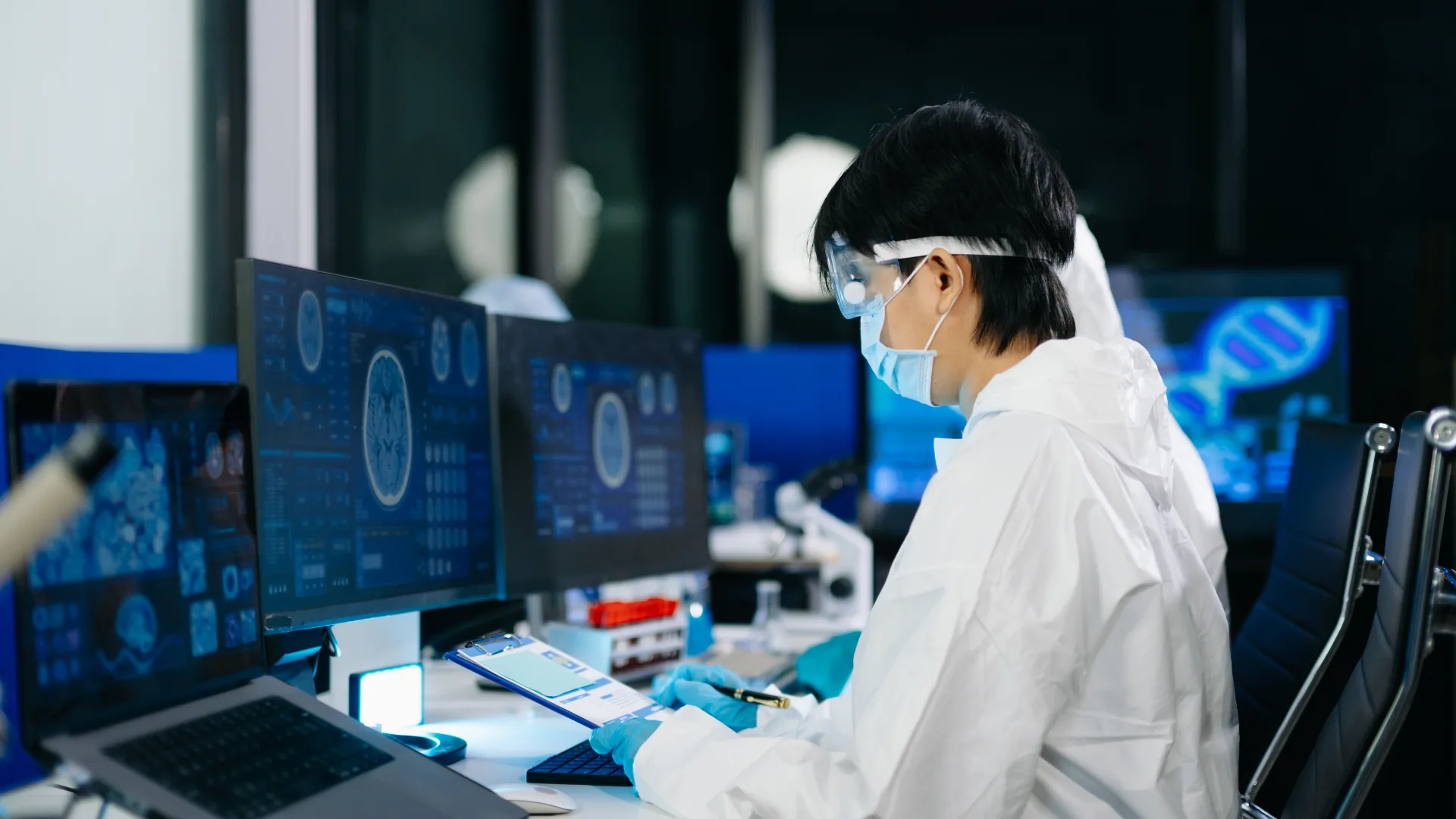 health care worker research logging work on computer